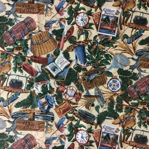 May include: A beige fabric with a repeating pattern of camping and fishing gear. The pattern includes a compass, fishing rod, fishing net, lantern, book, backpack, and a pot over a fire. The fabric also has the words "Outdoor Monthly" and "Western Trails" printed on it.