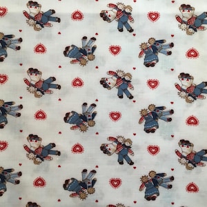May include: White fabric with a repeating pattern of red hearts and pairs of rag dolls holding hands. The dolls are wearing blue and red clothing.