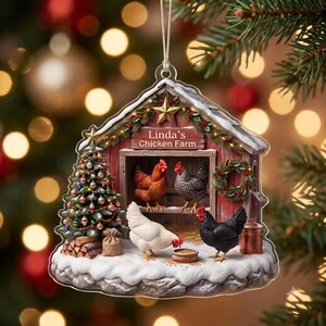 May include: A flat, house-shaped Christmas ornament featuring a red barn with the text Linda's Chicken Farm. The scene includes a decorated Christmas tree, a wreath, and four chickens in various colors, all set on a snow-covered base with a silver string.