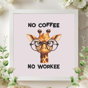 May include: Cross-stitch artwork featuring a giraffe wearing spectacles, with the text "NO COFFEE NO WORKE". The giraffe is brown with a spotted neck, set against a light pink background, framed in a white square.
