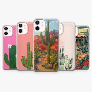 May include: A collection of five phone cases with desert-themed designs. The cases feature illustrations of cacti, desert landscapes, and floral elements in various colors, including pink, green, and orange. The cases are designed to fit a smartphone.