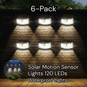 May include: Six solar-powered motion sensor lights mounted on a brick wall. Each light is square with a bright white glow, casting a downward beam. The text "6-Pack" is at the top. The lights are described as 120 LEDs and waterproof.