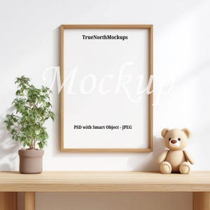 May include: A wooden framed mockup with the text "TrueNorthMockups" and "PSD with Smart Object - JPEG". A small potted plant and a teddy bear sit on a wooden surface.