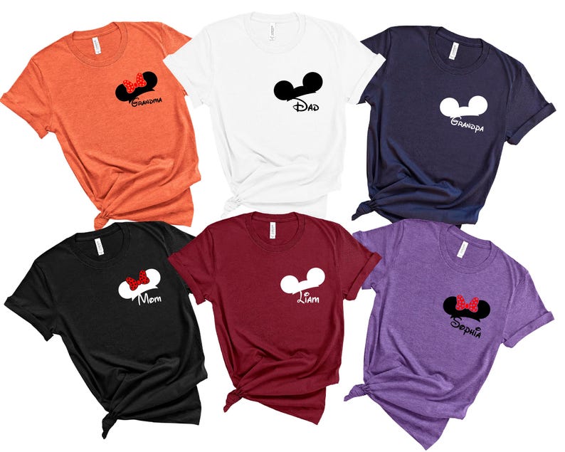 May include: A collection of six t-shirts in various colors, including orange, white, navy, black, burgundy, and purple. Each shirt features a Mickey Mouse ear design with text such as "Grandma," "Dad," "Grandpa," "Mom," "Liam," and "Sophia."