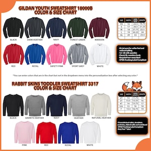 May include: Color and size chart for Gildan youth and Rabbit Skins toddler sweatshirts. The Gildan chart includes colors like black, navy, and red. The Rabbit Skins chart includes black, navy, and heather. Features include a classic fit and a recycled tear-away label.