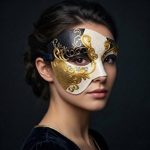 May include: A decorative half-mask in black, white, and gold. The mask features ornate scrollwork and musical notes, with a black strap. The mask is designed to cover the eye and cheek area, with a textured white and gold finish.