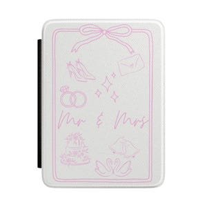 May include: A white rectangular protective cover featuring a pink line-art design of a bow, high heels, an envelope, diamond rings, sparkles, a tiered cake, wedding bells, and two swans, with the text "Mr & Mrs" printed in pink script.