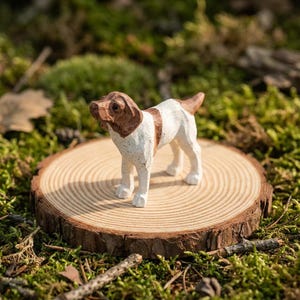 May include: A hand-carved wooden dog figurine with brown and white markings stands on a small, round wooden slice. The dog is posed in a standing position, with its head slightly turned. The wood slice has visible growth rings.