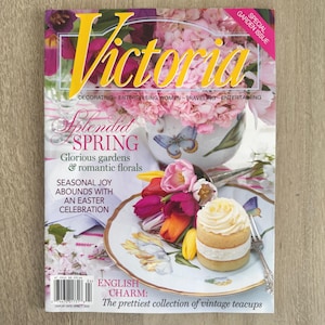 May include: A magazine cover with the title "Victoria" in yellow, featuring floral arrangements and a cake. The cover includes text about spring, gardens, and an Easter celebration. The magazine is a special garden issue.