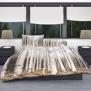 May include: A white and grey bedding set with a birch tree forest print. The bedding is made of soft, comfortable fabric and features a duvet cover and two pillowcases.
