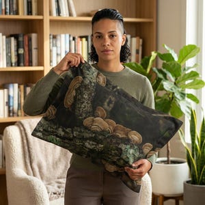 May include: A rectangular pillowcase with a print of tree bark and fungi in shades of brown and tan. The design has a dark, natural colour palette, suggesting a forest theme. The pillowcase is made of a soft fabric.