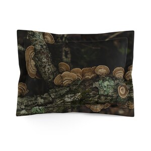 May include: Pillowcase with a print of a tree branch covered in brown, shelf-like fungi. The fungi have concentric rings and are set against a dark, blurred background. The branch also has patches of green moss.