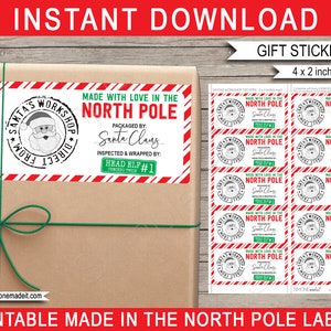 May include: Printable gift tags with a red and white striped border. The tags feature a black and white illustration of Santa Claus's workshop with the text "Made with Love in the North Pole" and "Packaged by: Santa Claus". The tags are 4 inches by 2 inches.