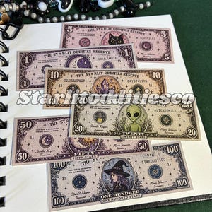 May include: A collection of rectangular paper notes labeled The Starlit Oddities Reserve in denominations of 1, 5, 10, 20, 50, and 100. Each note features intricate illustrations including a black cat, crystals, an alien, and a witch, with celestial motifs like moons and stars printed in various colors.