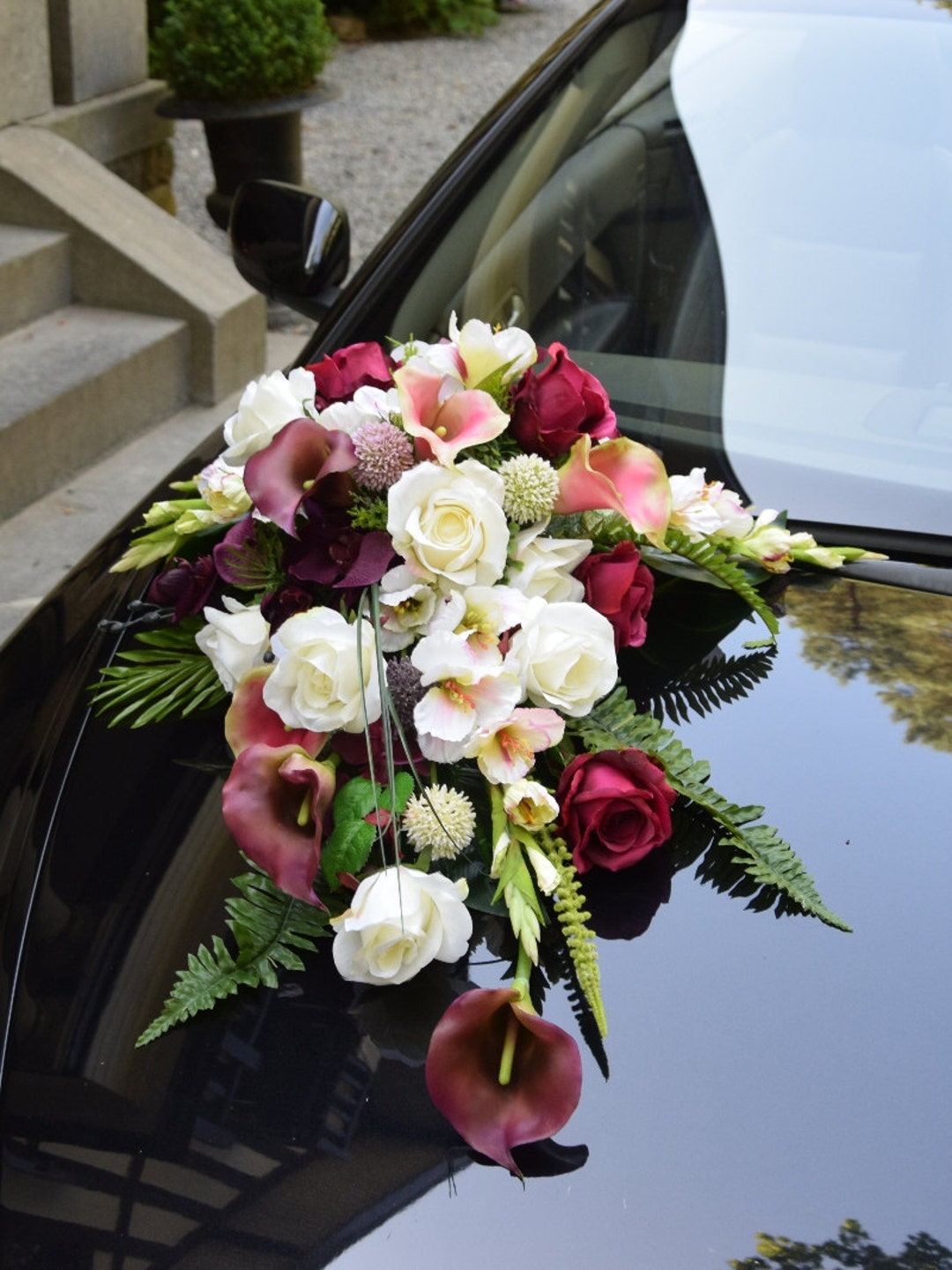 Wedding car decoration of flowers with roses and butterflies Stock