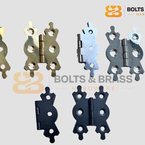May include: Selection of decorative cabinet hinges in gold, silver, and black finishes. The hinges feature an ornate design with rounded cutouts and decorative finials. The "BOLTS & BRASS HARDWARE" logo is visible in the top right corner.
