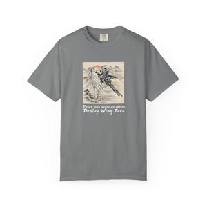 May include: Gray t-shirt with a graphic featuring a mech-like figure in a landscape with a red sun. The text "Peace was never an option" and "Deploy Wing Zero" are below the image.