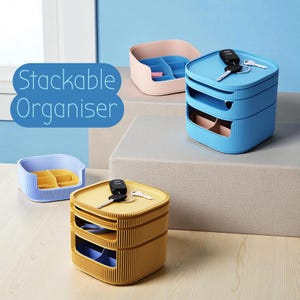 May include: Stackable organizer in blue, pink, and yellow. The blue organizer has two stacked compartments, with keys on top. The yellow organizer also has two stacked compartments, with keys on top. The pink and blue organizers are open-top.
