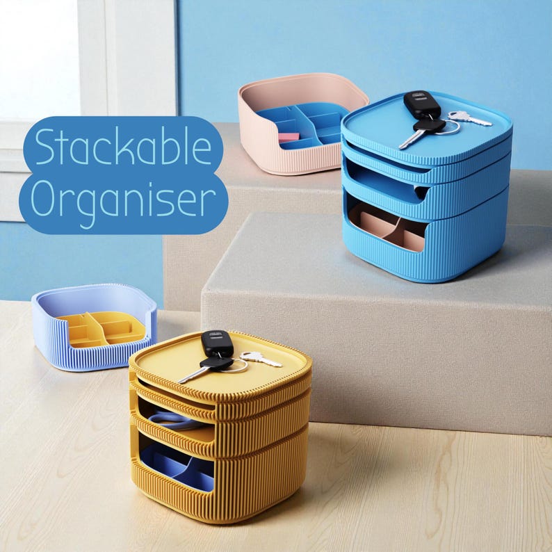 May include: Stackable organizer in blue, pink, and yellow. The blue organizer has two stacked compartments, with keys on top. The yellow organizer also has two stacked compartments, with keys on top. The pink and blue organizers are open-top.