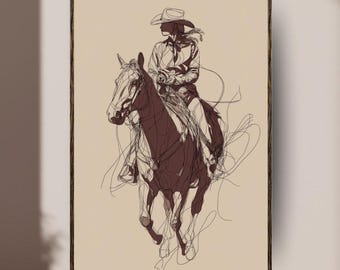 May include: A framed art print depicting a line drawing of a person riding a horse. The artwork is in brown tones on a beige backdrop. The rider is wearing a cowboy hat and shirt. The horse is shown in motion.