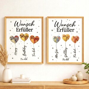 May include: Two framed prints with gold frames. Each print shows heart-shaped balloons made of currency, with numbers 20, 50, and 10. Text includes "Wunsch Erf&uuml;ller", "Happy Birthday", and "F&uuml;r dich".