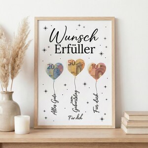 May include: A framed print with heart-shaped balloons made from Euro banknotes. The balloons display the numbers 20, 50, and 10. The print includes the text "Wunsch Erf&uuml;ller" and other German phrases.