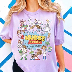 May include: A light purple t-shirt featuring a cartoon graphic with the words "NURSE STORY" in yellow and red. The graphic includes various cartoon characters dressed as nurses and medical supplies. The text "TO INFINITY AND BEYOND FOR OUR PATIENTS" is also included.