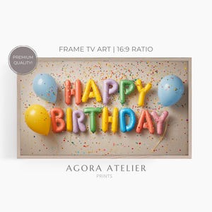 May include: A framed print with the words "HAPPY BIRTHDAY" in colorful balloon letters, accompanied by blue and yellow balloons. The background is speckled with confetti. The print is labeled "FRAME TV ART | 16:9 RATIO".