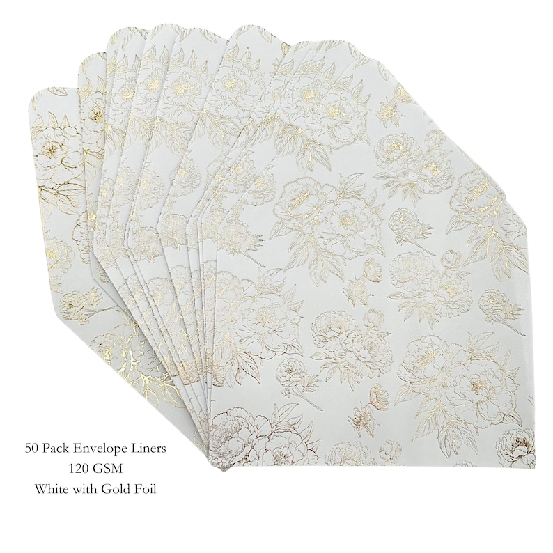 May include: A stack of white envelope liners with a gold floral pattern. The liners are made of 120 GSM paper and are white with gold foil accents. The text on the image reads: "50 Pack Envelope Liners 120 GSM White with Gold Foil."