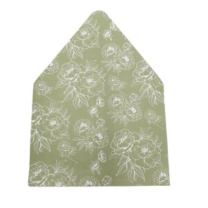 May include: A sage green envelope with a white floral pattern featuring peony blooms and leaves. The envelope has a unique, pointed top and is likely used for invitations or stationery.