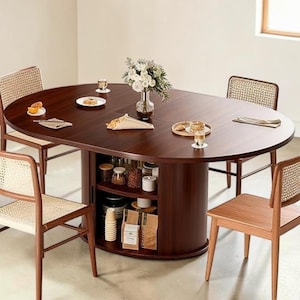 May include: A dark brown oval dining table with a built-in storage cabinet, surrounded by four wooden chairs with woven backs. The table is set with plates, glasses, and a vase of flowers. The table is approximately 60 inches long.