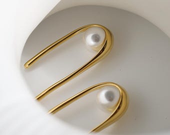 Örhängen med öppna U-formade pärlor