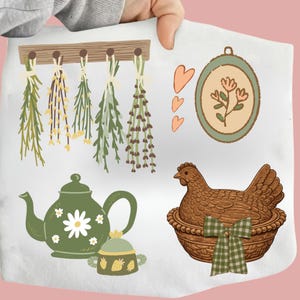 May include: A collection of illustrated elements featuring a green teapot with a daisy design, a sugar bowl with strawberries, hanging herbs, a framed floral design, and a hen in a basket with a green and white bow.