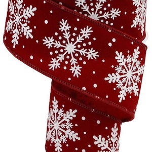 May include: A roll of red ribbon with white snowflake and dot patterns. The ribbon is made of a soft material and is ideal for holiday decorations, gift wrapping, and craft projects. The snowflakes are detailed and evenly spaced.