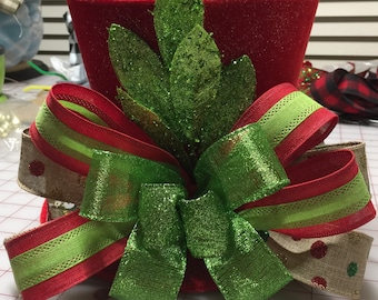 Christmas tree topper top hat red with lime green bay leaves About to run out of red and lime ribbon. Will need to substitute but same color