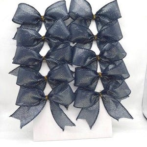 May include: A collection of ten dark navy blue bows arranged in two vertical columns on a white display card. Each bow is crafted from a semi-sheer, mesh-like fabric with a fine grid pattern and is secured at the center with a small gold-colored wire.