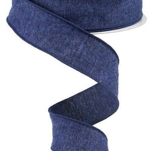 May include: A roll of 2.5 inch wide denim ribbon in a dark blue color. The ribbon has a textured surface and is perfect for crafting and decorating.