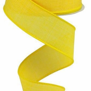 Peut inclure: Un rouleau de ruban jaune vif avec une finition satinée. Le ruban mesure 2,5 pouces de large et a une texture subtile.