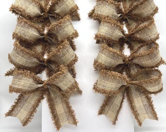 May include: A set of eight decorative bows arranged in two vertical columns on a white display card. Each bow is crafted from a tan and beige checkered fabric featuring frayed, textured edges and a central knot detail for a rustic appearance.