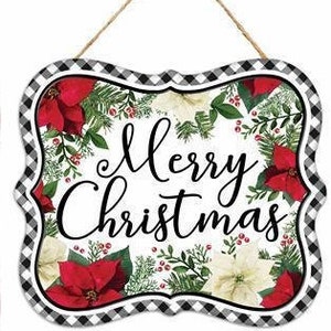Op de afbeelding: Een wit bord met een zwart-wit geblokte rand. Het bord heeft een bloemmotief met rode en witte bloemen en groene bladeren. Op het bord staat "Merry Christmas" in zwarte, cursieve letters.