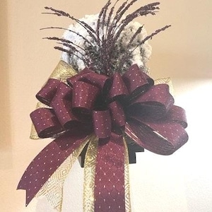 Christmas Tree Topper snowy rattan top hat trimmed in gold and maroon ribbon and a maroon glittered stem