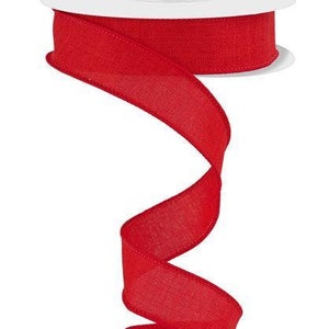 May include: A spool of red wired ribbon with a textured finish. The ribbon is curled and twisted, showing off its texture and color.
