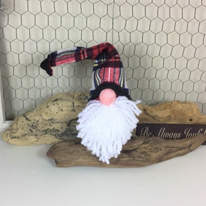 Hand Crafted Gnome Wearing a Plaid Hat Sporting a White Yarn Beard on a Red Sock Body