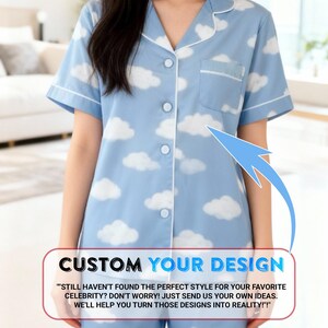 A woman wearing a blue pajama top with a cloud pattern, standing in a room with a couch and a window in the background.