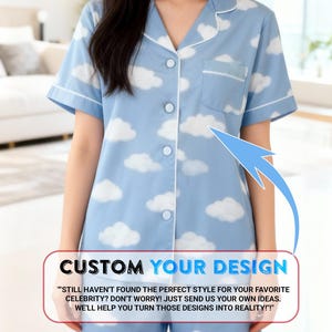 A woman wearing a blue pajama top with a cloud pattern, standing in a room with a couch and a window in the background.