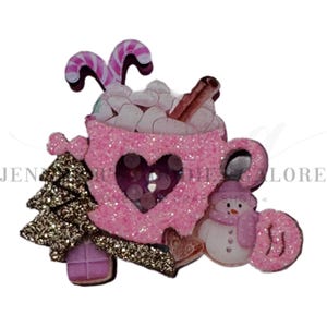 May include: A pink glittery Christmas-themed decoration featuring a mug of hot chocolate with marshmallows, candy canes, and a cinnamon stick. Includes a Christmas tree, a snowman, and a heart-shaped cutout. The text "JEN... ONE TIME CRAFT SHOP" is visible.