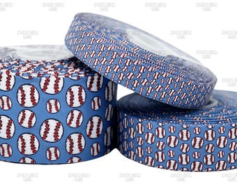 May include: Three spools of baseball-themed ribbon. The ribbon is light blue with a repeating pattern of white baseballs with red stitching. The spools are stacked, with one partially unrolled, showcasing the design.