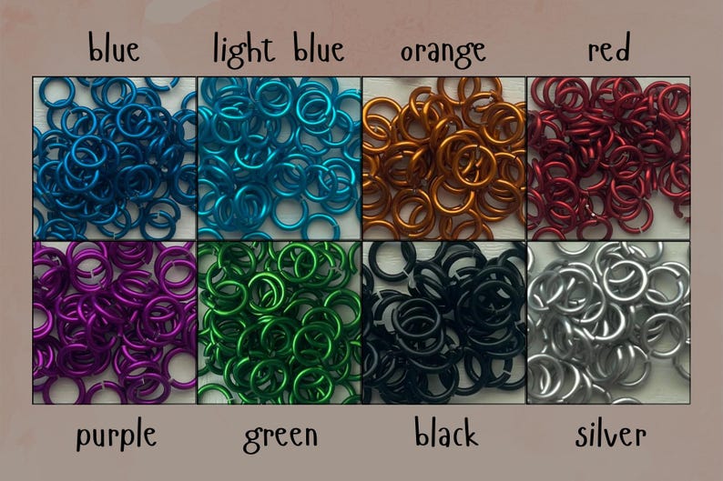 May include: A collection of colorful metal jump rings in blue, light blue, orange, red, purple, green, black, and silver. Each color is displayed in a separate square, with the color name written below each square.