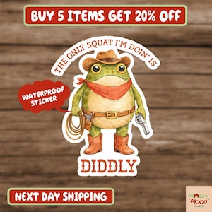 May include: A waterproof sticker featuring a cartoon frog dressed as a cowboy, wearing a hat, boots, and a red bandana. The frog is holding a lasso and a gun, with the text "The only squat I'm doin' is DIDDLY".