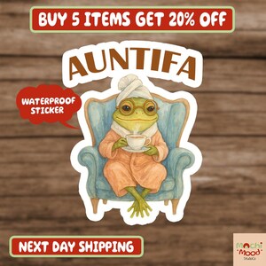 May include: Auntifa waterproof sticker featuring a frog in a robe, glasses, and a towel on its head, holding a teacup while seated in a blue armchair. The sticker has the text "AUNTIFA" and "WATERPROOF STICKER".